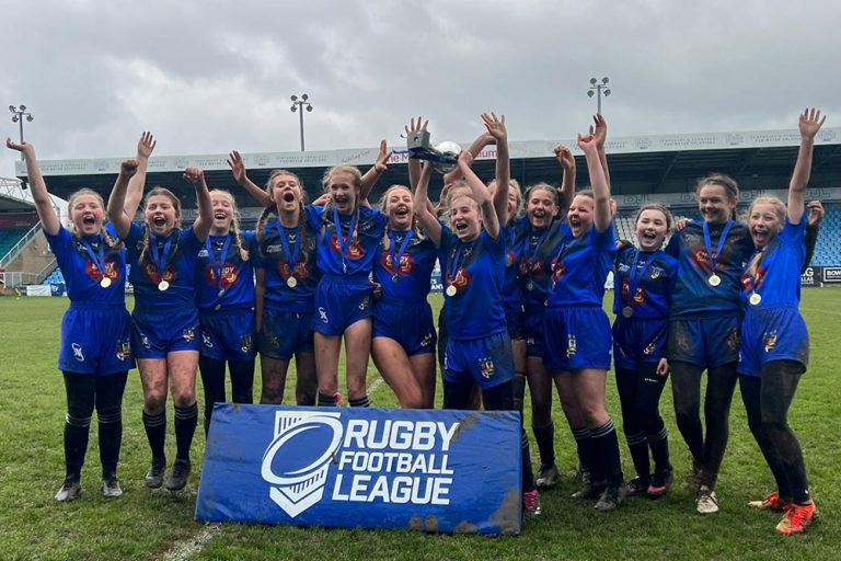 Malet Year 8 girls rugby team celebrating their Yorkshire Cup final win