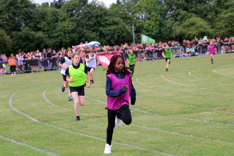 pupils racing on the track during sports day